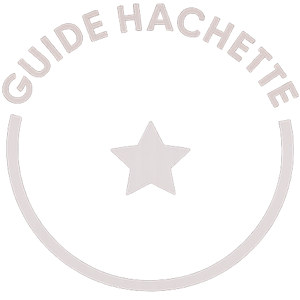 Le macaron Guide Hachette à une étoile apparaît sur fond noir, associé à la cuvée Fleuron de Champagne de la Renaissance et à son image d’excellence.